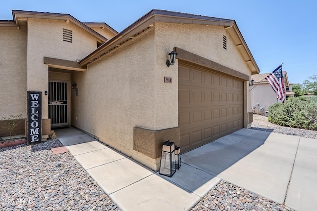 941 E Desert Moon Trl, San Tan Valley, AZ 85143 - view of property exterior with an attached garage and stucco siding