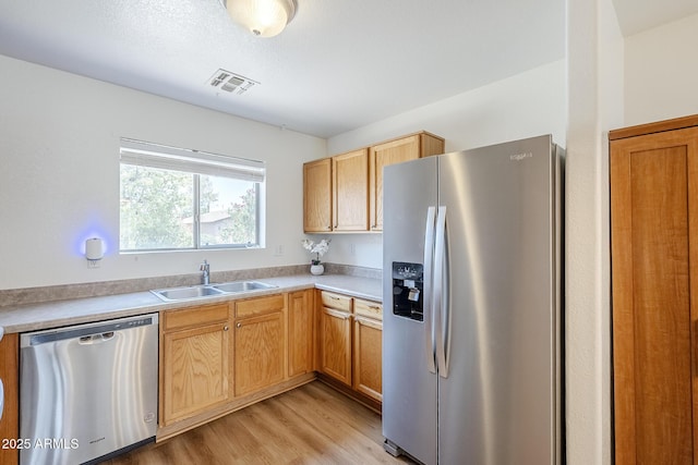 941 E Desert Moon Trl, San Tan Valley, AZ 85143 - kitchen with stainless steel appliances, light wood-style floors, and light countertops