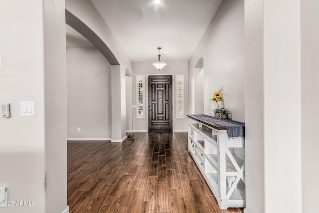 19571 E Strawberry Dr, Queen Creek, AZ 85142 - entryway featuring arched walkways, dark wood-type flooring, and baseboards