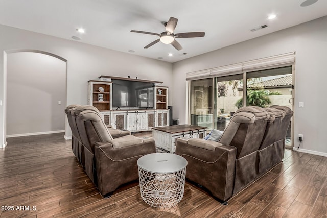 19571 E Strawberry Dr, Queen Creek, AZ 85142 - living room with dark wood-style floors, visible vents, arched walkways, and a ceiling fan