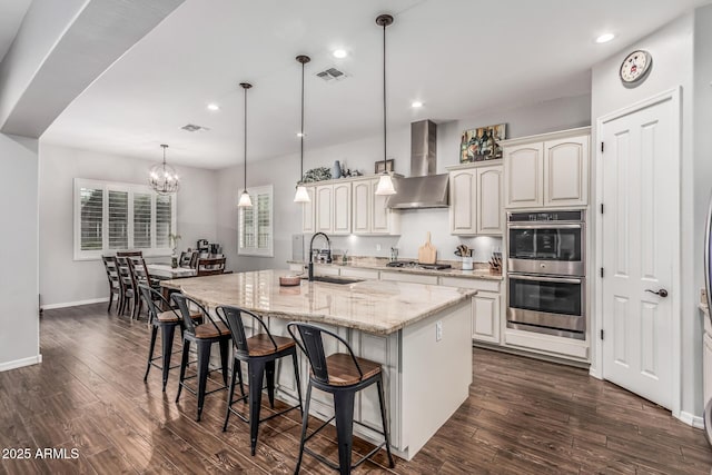 19571 E Strawberry Dr, Queen Creek, AZ 85142 - kitchen featuring dark wood-style flooring, visible vents, wall chimney exhaust hood, stainless steel appliances, and a sink