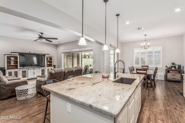 19571 E Strawberry Dr, Queen Creek, AZ 85142 - kitchen with a sink, a breakfast bar area, dark wood finished floors, ceiling fan with notable chandelier, and visible vents