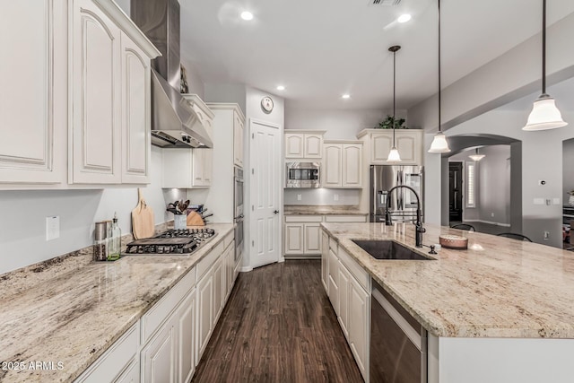 19571 E Strawberry Dr, Queen Creek, AZ 85142 - kitchen featuring a sink, a center island with sink, dark wood-style floors, stainless steel appliances, and arched walkways