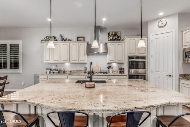 19571 E Strawberry Dr, Queen Creek, AZ 85142 - kitchen featuring a kitchen breakfast bar, stainless steel appliances, and wall chimney exhaust hood