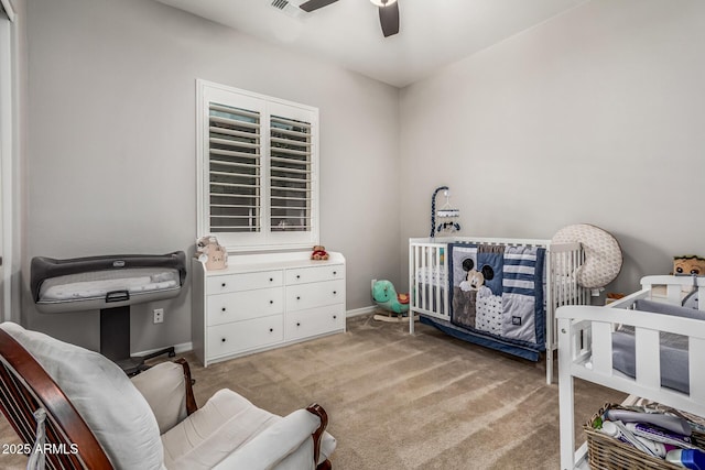 19571 E Strawberry Dr, Queen Creek, AZ 85142 - bedroom with a crib, a ceiling fan, light carpet, baseboards, and visible vents
