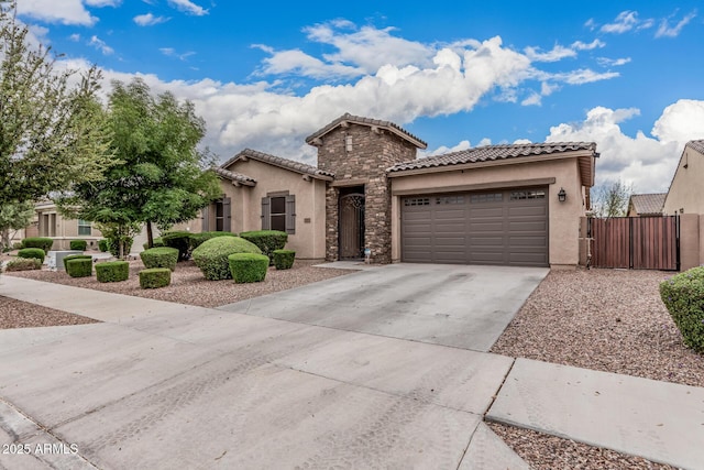 19571 E Strawberry Dr, Queen Creek, AZ 85142 - mediterranean / spanish-style house featuring a tiled roof, concrete driveway, stucco siding, and an attached garage