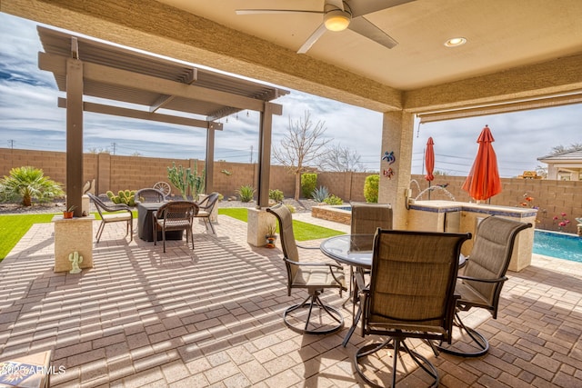 view of patio / terrace with outdoor dining space, a fire pit, a fenced in pool, and a fenced backyard