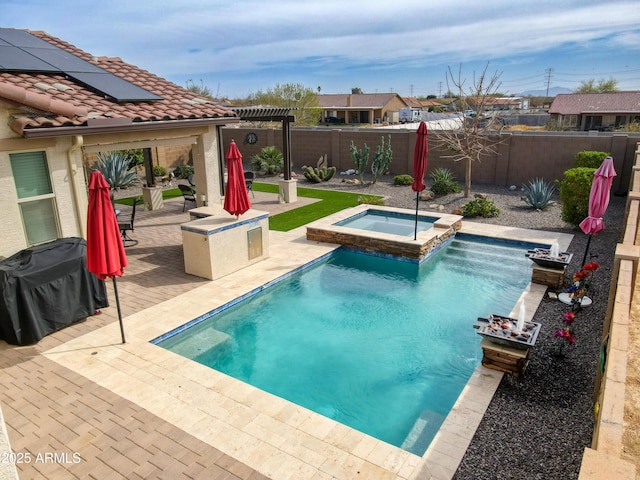 view of pool with a patio, a fenced backyard, a pool with connected hot tub, and grilling area