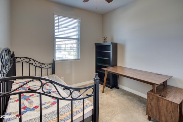 carpeted bedroom with ceiling fan and baseboards