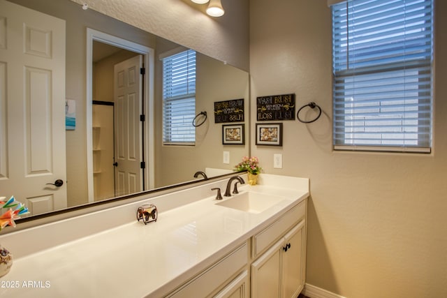 bathroom with vanity and baseboards