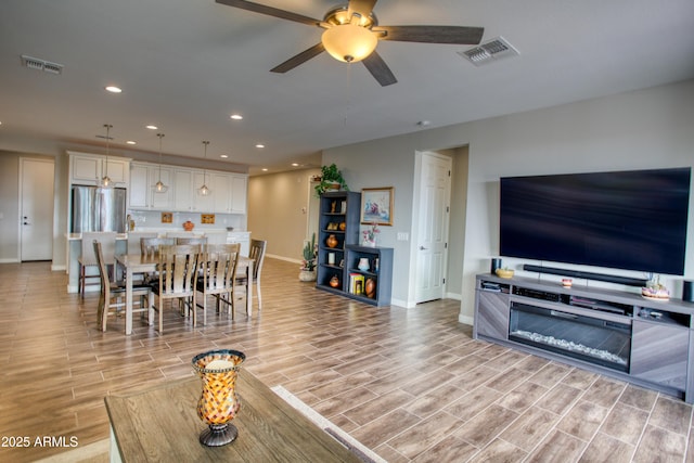 dining area with wood finish floors, recessed lighting, visible vents, and ceiling fan