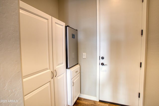 interior space featuring light countertops, white cabinets, and wood finished floors