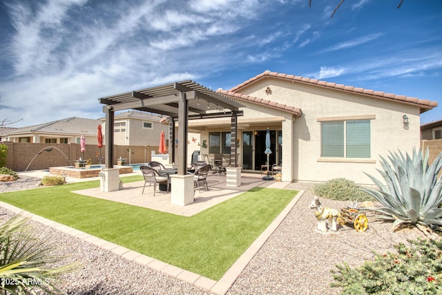 rear view of house with stucco siding, a lawn, a pergola, a patio, and fence