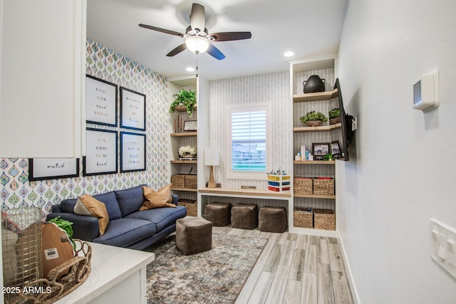 living area featuring wood finished floors, baseboards, wallpapered walls, recessed lighting, and ceiling fan