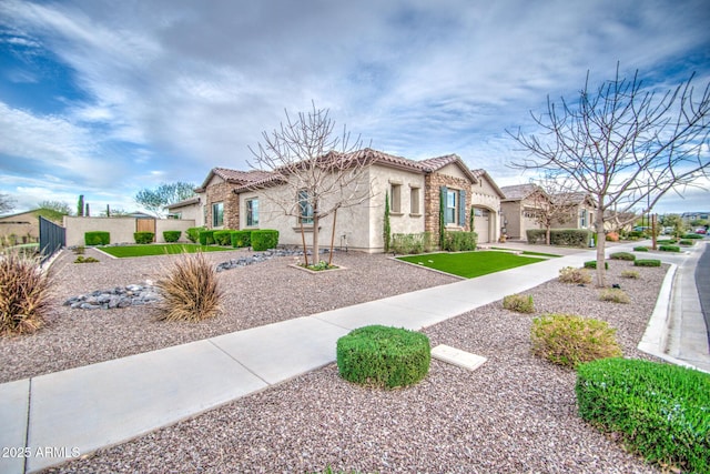 mediterranean / spanish-style house with a residential view, stucco siding, a tiled roof, and fence