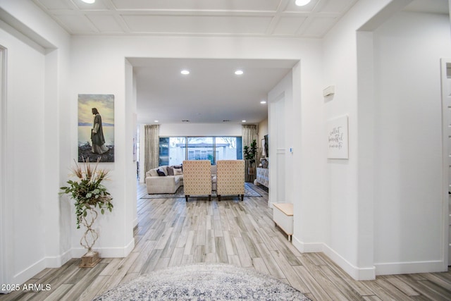 hallway with recessed lighting, light wood-style floors, and baseboards