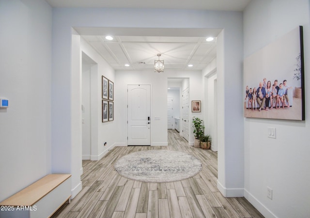 entrance foyer featuring recessed lighting, coffered ceiling, baseboards, and wood finished floors