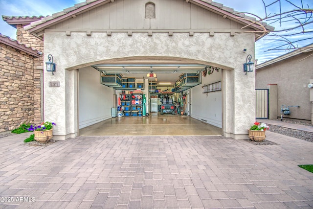 garage with decorative driveway