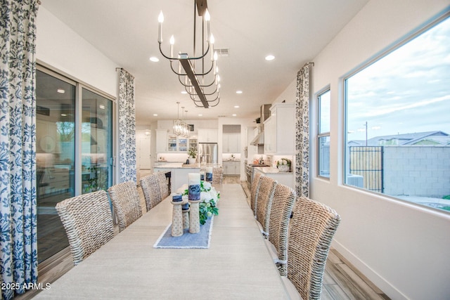 dining area featuring light wood-style floors, an inviting chandelier, recessed lighting, and visible vents