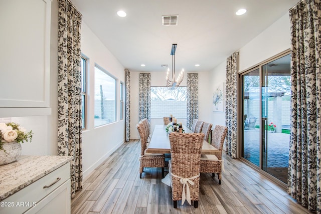 dining area with a wealth of natural light, visible vents, recessed lighting, and light wood-type flooring