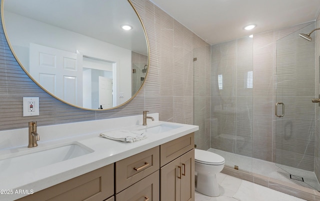 bathroom with toilet, an enclosed shower, tile walls, tile patterned floors, and vanity