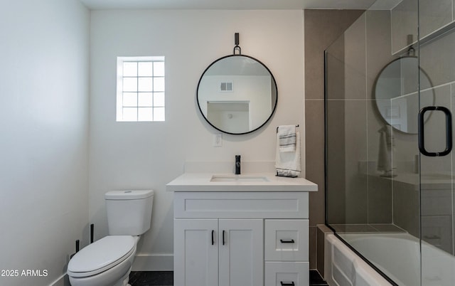 full bathroom featuring shower / bath combination with glass door, toilet, and vanity