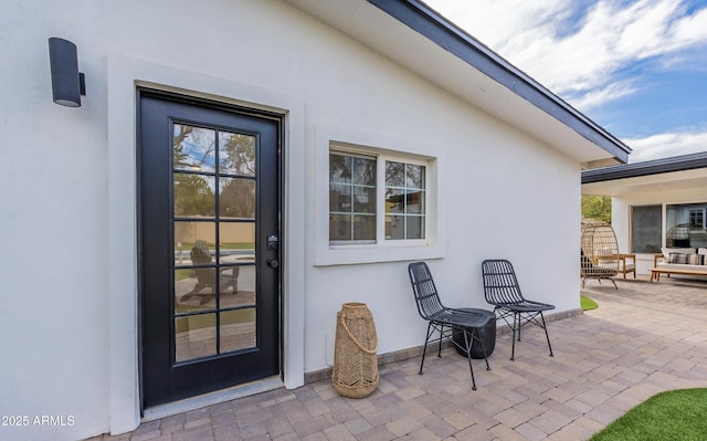 doorway to property with a patio