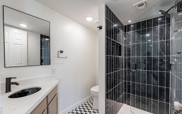 bathroom featuring vanity, toilet, and walk in shower