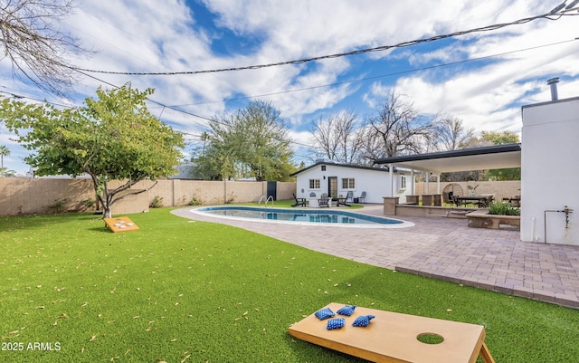 view of pool featuring a patio and a yard