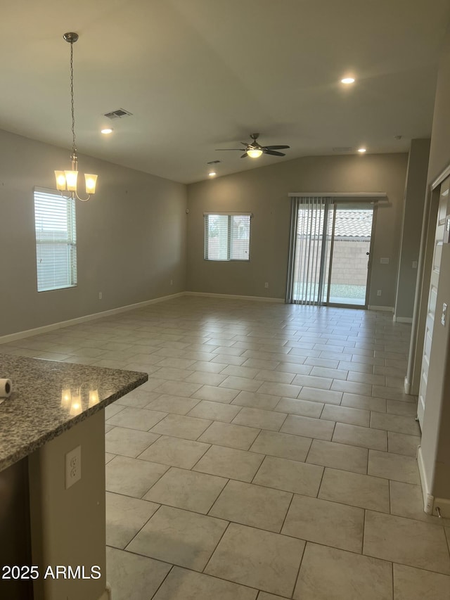 unfurnished living room featuring light tile patterned flooring, lofted ceiling, and ceiling fan with notable chandelier