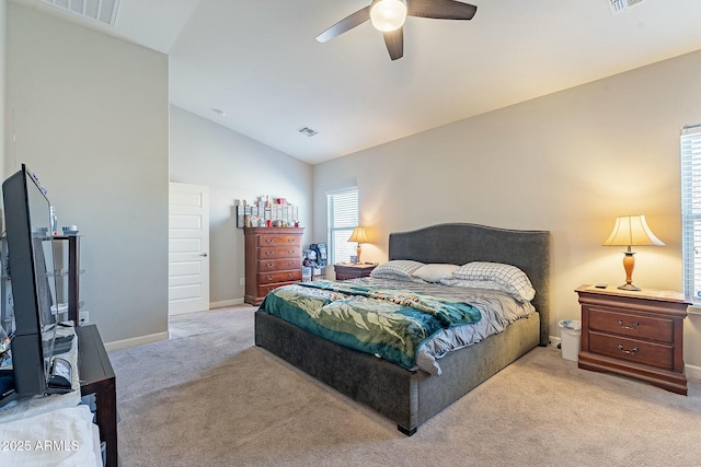 carpeted bedroom with vaulted ceiling and ceiling fan