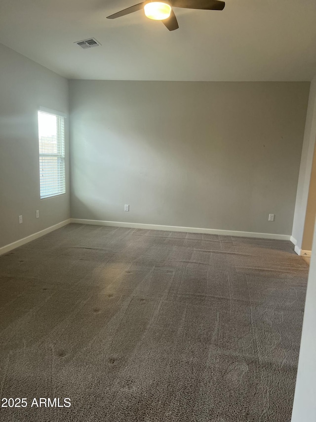 carpeted spare room with ceiling fan