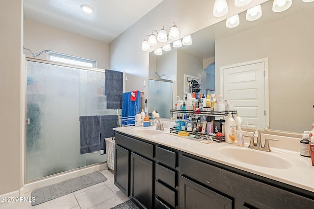 bathroom with tile patterned flooring, vanity, and a shower with door