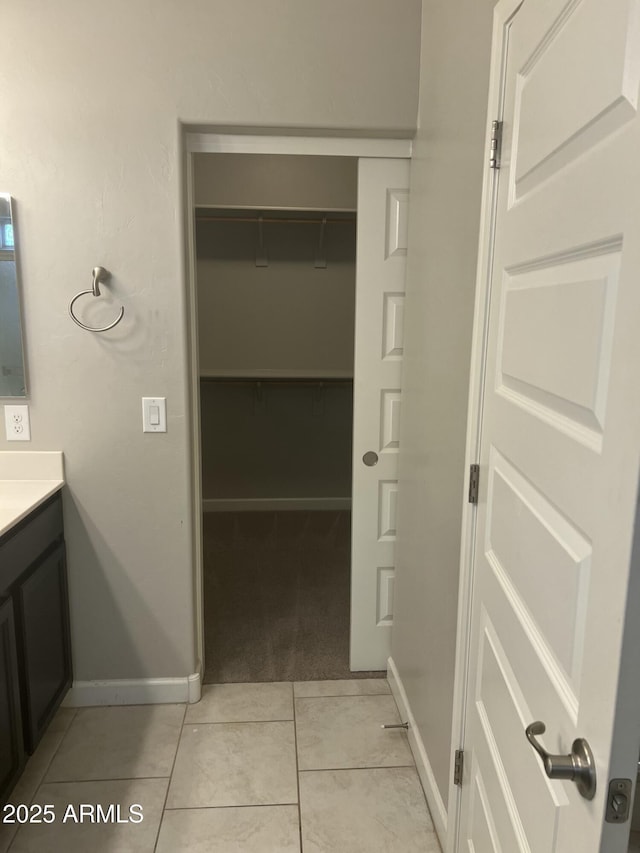 bathroom with tile patterned flooring and vanity