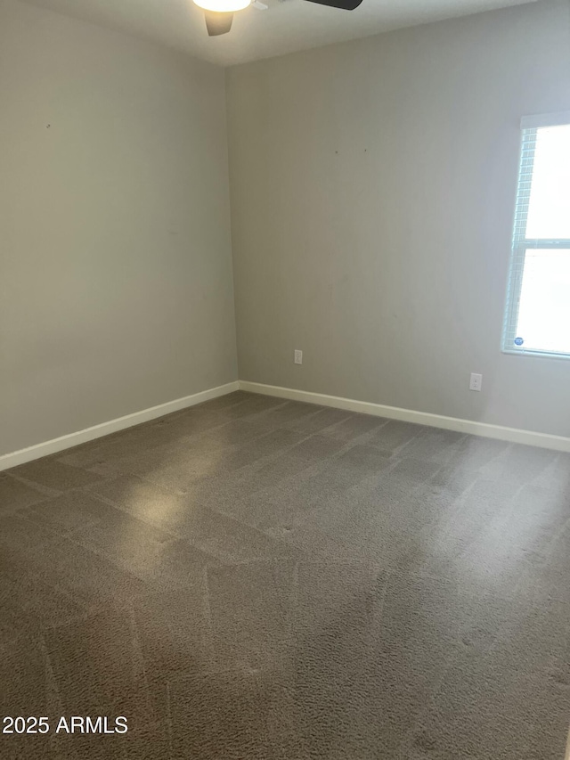 spare room featuring carpet floors and ceiling fan