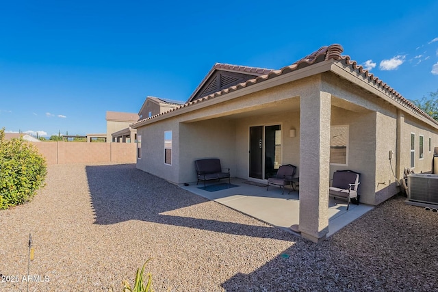 rear view of house featuring cooling unit and a patio