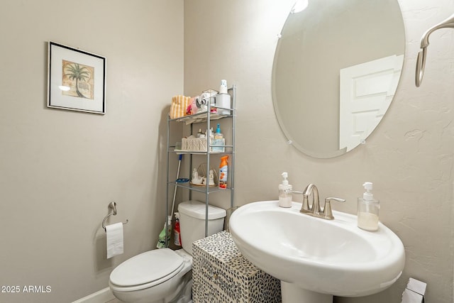 bathroom featuring sink and toilet