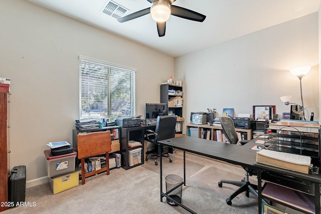 office space featuring light carpet and ceiling fan