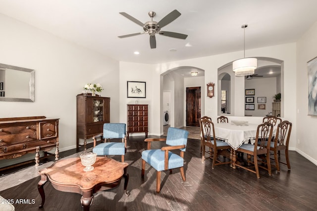 interior space with dark hardwood / wood-style flooring, washer / dryer, and ceiling fan