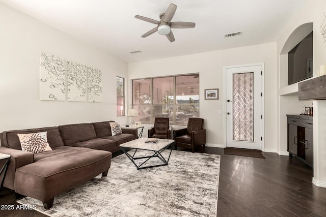 living room featuring dark hardwood / wood-style floors and ceiling fan