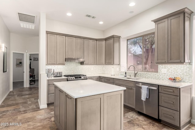 kitchen with sink, range, a center island, dishwasher, and backsplash