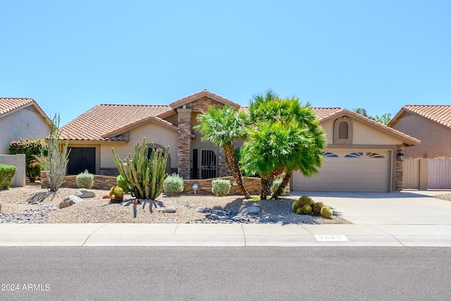 view of front of home featuring stucco siding, concrete driveway, an attached garage, and a tiled roof