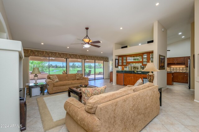 tiled living room featuring ceiling fan