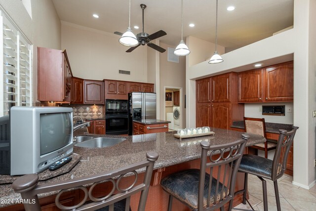 kitchen with tasteful backsplash, sink, ceiling fan, stainless steel fridge with ice dispenser, and black microwave