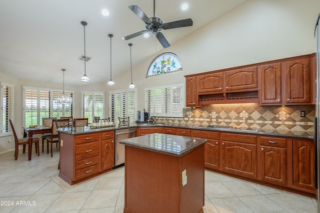 kitchen with a kitchen island, ceiling fan, decorative light fixtures, and a healthy amount of sunlight