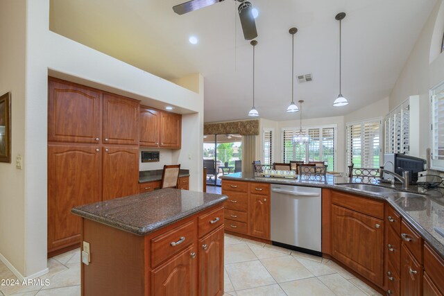 kitchen with decorative light fixtures, stainless steel dishwasher, a center island, sink, and ceiling fan