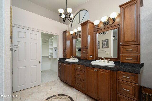 bathroom with vanity, a notable chandelier, and tile patterned flooring