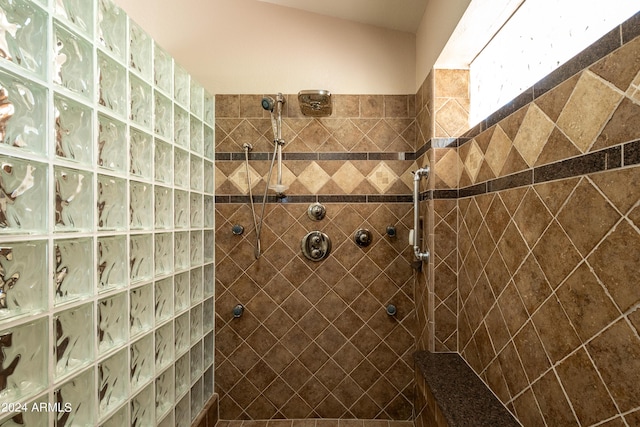 bathroom with a tile shower