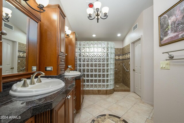 bathroom featuring tiled shower, vanity, and tile patterned floors