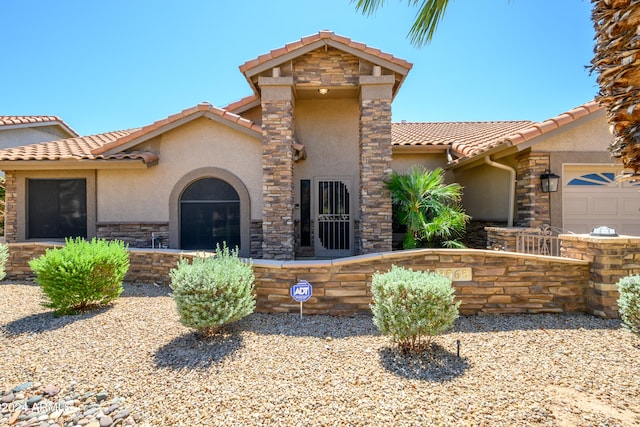 mediterranean / spanish house with a garage